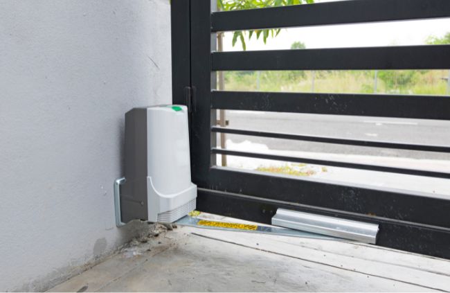 Electric gate motor installation by Auto Gate Guys Adelaide showing the motor housing, drive rail and gate track used for automated sliding driveway access.